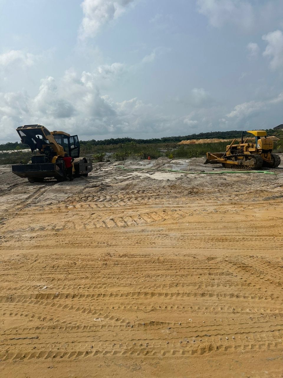 Machinery during sand filling and site preparation